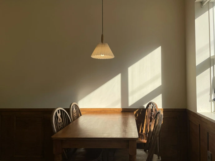 Wooden table and chairs bathed in sunlight